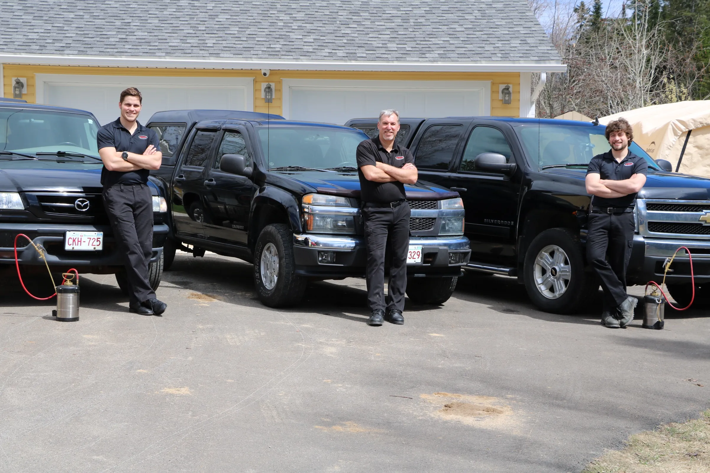 The Durelle Pest Management crew with their service trucks in Fredericton, New Brunswick